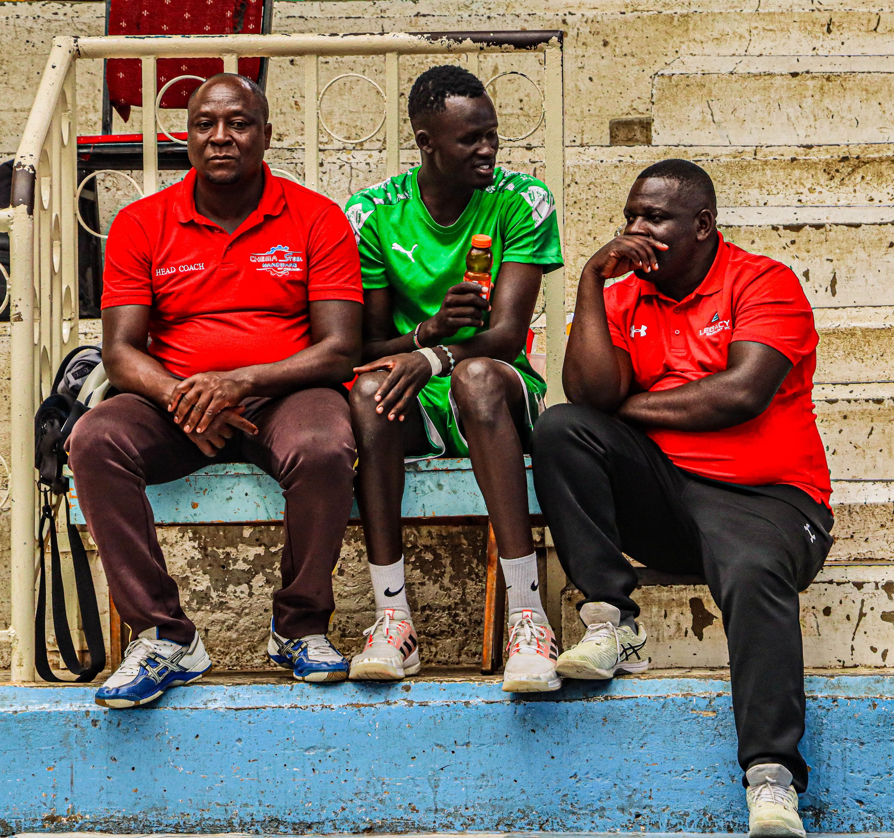 Chema VC bench staff and player seated during a match break