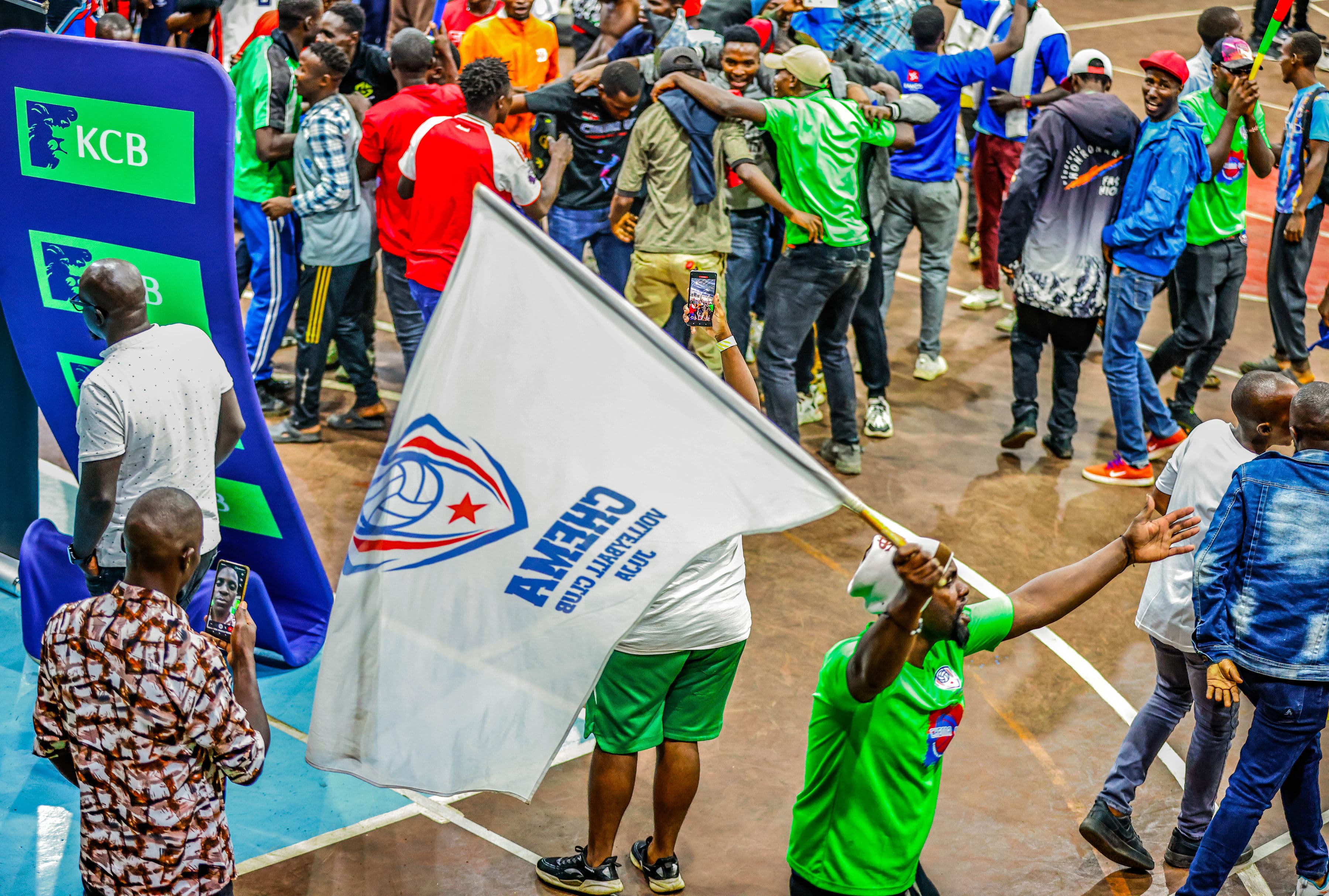 Chema VC supporters celebrating while waving the club flag